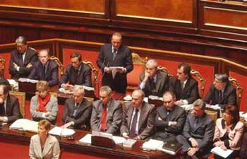 Italian Premier Silvio Berlusconi, center standing, delivers his address at a session in the Senate on the release in Iraq of Italian journalist Giuliana Sgrena and the death of intelligence agent Nicola Calipari, in Rome Wednesday March 9, 2005. [AP]