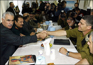 Haj Ismail Jabr, the top Palestinian security official in the West Bank (L), shakes hands with Tal Ruso, the Israeli military chief of the Jordan Valley area, during their meeting in the West Bank city of Jericho.(AFP/Awad Awad) 