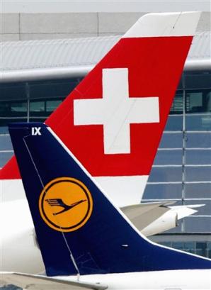 An airplane of the German airline Lufthansa rolls in front of an airplane of the Swiss International Air Line, on Unique Zurich Airport in Kloten, Switzerland, June 4, 2004 file picture. German carrier Lufthansa and loss-making Swiss International Air Line have agreed on a planned union of the two carriers, as Lufthansa confirmed on Sunday, March 13, 2005. (AP PhotoKEYSTONE/Steffen Schmidt)