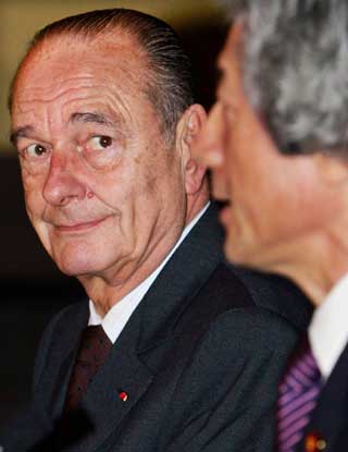 French President Jacques Chirac (L) listens to Japanese Prime Minister Junichiro Koizumi's speech during a joint news conference after their summit meeting in Tokyo March 27, 2005. Chirac is on a three-day official visit to Japan. 