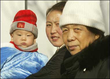 A baby, mother and grandmother walk together on a street in Beijing. Slowly but surely, women in China who struggle to conceive are realizing there is hope out there and they do not have to helplessly suffer the intense stigma of being childless in a society that places supreme importance on having kids(AFP/