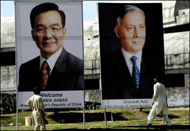 Two Pakistani men look at huge portraits of Pakistani Prime Minister Shaukat Aziz (R) and his Chinese counterpart Wen Jiabao (L) erected in front of the parliament in Islamabad. Wen was due to begin his first visit to Pakistan on his maiden South Asian tour as premier(AFP