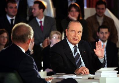French President Jacques Chirac, right, gestures during a live television appearance at the Elysee Palace in Paris, Thursday April 14, 2005. Chirac has chosen a televised two-hour debate with 80 young French peolple to make his first campaign pitch for a 'Yes' in the May 29 referendum. (AP Photo/Patrick Kovarik, Pool)