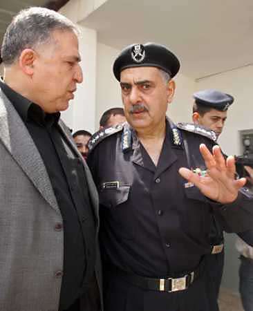 New Palestinian police chief Ala Hosni(L) walks with former police chief Mahmoud Asfor, who was forced into retirement by Palestinian President Mahmoud Abbas, in Gaza April 24, 2005. Abbas has named three new security commanders as part of a major shake-up expected to push about 1,000 security men into retirement, a presidential aide said on Saturday. Photo by Suhaib Salem/Reuters