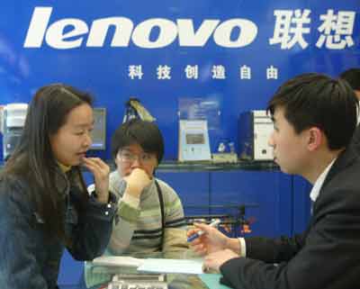 A Chinese salesman (R) talks with the customers in front of Lenovo signage at a computer shop in Beijing in this March 10, 2005 file photo. Three U.S. private equity firms - Texas Pacific Group, General Atlantic LLC and Newbridge Capital LLC - have agreed to invest US$350 million in the Lenovo Group Ltd., the Chinese computer maker that is buying IBM's personal computer business, the parties confirmed on Wednesday. [Reuters]