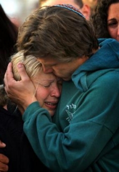 Jan Talasnikov comforts his mother Lea during the funeral of his brother Dan Talasnikov, an Israeli army soldier, at the cemetery of the town of Nir Galim, Israel , Monday May 2, 2005. Talasnikov, 21 , was killed when Israeli troops raided the Palestinian West Bank village of Seideh near Tulkarem before dawn Monday and imposed a curfew. A shootout erupted, leaving a militant and the soldier dead.(AP 