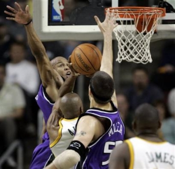 Sacramento Kings guard Maurice Evans, left, and center Brad Miller, second from right, squeeze out Seattle SuperSonics guard Ray Allen in the first half, Tuesday, May 3, 2005, in Game 5 of the first round playoff series in Seattle. (AP