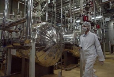 Wearing protective clothes, an Iranian security personel walks in the Uranium Conversion Facility, prior to the arrival of Iranian President Mohammad Khatami, just outside the city of Isfahan, 410 kilometers, south of the capital Tehran, Iran, in this March 30, 2005 file photo. Iran confirmed for the first time Monday May 9, 2005 that it converted 37 tons of raw uranium into gas, a key step ahead of enrichment, before it suspended all such activities in November under international pressure.Natanz and the uranium conversion facility in Isfahan house the heart of Iran's nuclear program. The Isfahan conversion facility reprocesses uranium ore concentrate into gas, which is taken to Natanz and fed into centrifuges for enrichment. (AP