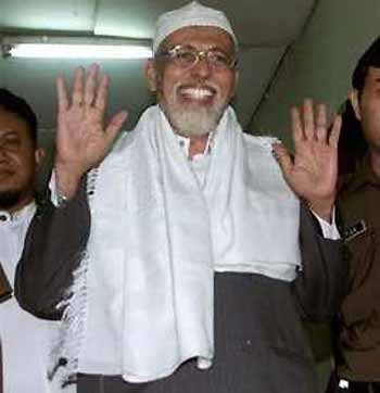 Militant Muslim cleric Abu Bakar Bashir waves to journalists after his trial in Jakarta, Indonesia in this Feb. 22, 2005 file photo. Indonesia's high court has upheld a 30-month prison sentence for accused terror chief Abu Bakar Bashir for conspiracy in the 2002 Bali nightclub bombings, a court official said Monday, May 16, 2005.