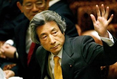Japan's Prime Minister Junichiro Koizumi raises a hand before he answers oppositions' questions at the Parliamentary committee meeting at the National Diet in Tokyo, Monday, May 16, 2005. Koizumi, speaking at the meeting, said he saw nothing wrong with his visits to Yasukuni shrine, which honors war dead including convicted war criminals. (AP