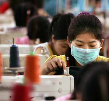 Chinese workers sew T-shirts in a garment factory at Dongguan in South China's Guangdong Province May 27, 2005. The European Union started a 15-day clock ticking on possible Chinese textile import curbs on Friday but held out hope for a "mutually satisfactory" agreement with Beijing despite advancing the May 31 deadline for action. The EU Executive Commission, in charge of trade policy in the 25-nation bloc, said intensive talks would take place starting on Monday at all levels with China over its surging textile exports. [Reuters]