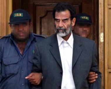 Saddam Hussein could go on trial for crimes against humanity within two months, far earlier than expected, Iraq's new president, Jalal Talabani, said on May 31 2005. Asked in an interview televised on CNN when Saddam's trial would begin, Talabani said: 'I hope within two months.' Iraq's deposed dictator Saddam Hussein is led by guards into the courtroom to appear before an Iraqi tribunal July 1, 2004. (Pool/Reuters) 