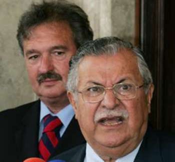 Iraqi President Jalal Talibani (R), with Luxembourg Foreign Minister Jean Asselborn beside him, speaks to reporters after a meeting with EU officials in Baghdad June 9, 2005. 