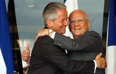 Honduran President Ricardo Maduro, left, and Nicaraguan President Enrique Bolanos, right, embrace following the 5th Ordinary Assembly for the System of Central American Integration (SICA) in Tegucigalpa, Honduras, Thursday, June 30, 2005.