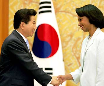 U.S. Secretary of State Condoleezza Rice (R) shakes hands with South Korean President Roh Moo-hyun during their meeting at the presidential house in Seoul, July 13, 2005. 