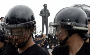 South Korean riot police officers stand guard near a statue of U.S. Gen. Douglas MacArthur during a demonstration at a war memorial housing a statue of U.S. Gen. Douglas MacArthur in Incheon, west of Seoul, Sunday, July 17, 2005. 