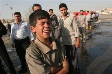 An Iraqi boy cries after he learns his father, a bus driver, was killed in two massive car bombs that exploded at a main bus station, Wednesday, Aug. 17, 2005, in Baghdad, Iraq.