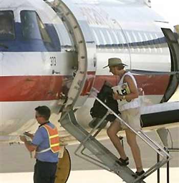 Cindy Sheehan, the grieving woman who started an anti-war demonstration near President Bush's ranch nearly two weeks ago, boards a plane at the Waco Regional Airport in Waco, Texas, Thursday, Aug. 18, 2005. Sheehan told reporters she had just received a phone call that her 74-year-old mother had a stroke and was leaving immediately to be with her at a Los Angeles hospital. (AP