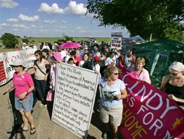 Supporters of Cindy Sheehan's anti-war movement carry a message to first lady Laura Bush as the protesters prepare to march along Prairie Chapel Road that leads to President Bush's ranch in Crawford, Texas, Thursday, Aug. 18, 2005. The march continued despite the departure of Sheehan, president of the Gold Star Families for Peace, who left the encampment abruptly Thursday afternoon on the news that her mother was in faltering health. (AP 