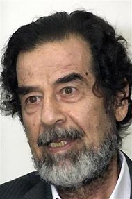 Former Iraqi dictator Saddam Hussein is seen in this photo released by the Iraqi Special Tribunal, showing Hussein having a meeting with Judge Munir Haddad at an initial appearance for crimes against Shiite Faili Kurds, Thursday, July 21, 2005, in Baghdad, Iraq.