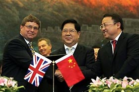 Britain's Prime Minister Tony Blair, background, left, watches as from left, Iain Gray MD of Airbus UK, Phillipe Lim Vice President of Airbus China, and Si Xinmin Presidant of China Southern Airlines Ltd agree a purchase agreement for ten Airbus 330's, during the EU/China summit in the Great Hall of the People, Beijing, China, Tuesday Sept. 6, 2005. Prime Minister Blair, is in China for two days for the EU/China Summit meeting.
