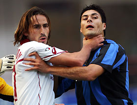 nter Milan's Julio Cruz (R) fights with Alessandro Grandoni of Livorno (L) during their Italia Serie A match at the San Siro Stadium in Milan, northern Italy, October 16, 2005. REUTERS/Daniele La Monaca z DLM/YH ? 3S ? en