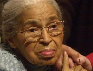 Civil rights pioneer Rosa Parks holds the hand of a well-wisher at a ceremony honoring the 46th anniversary of her arrest for civil disobedience Saturday, Dec. 1, 2001, at the Henry Ford Museum in Dearborn, Mich.