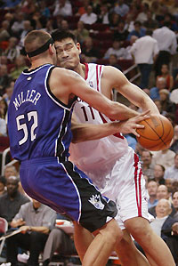 Houston Rockets center Yao Ming collides with Sacramento Kings center Brad Miller as he drives to the basket in the second half as the Rockets beat the Kings 98-89 November 2, 2005 in Houston.