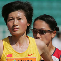 Xing Huina (L) runs in front of Japan's Hiromi Ominami during the women's 5000 metre final at the 4th East Asian Games in Macau November 4, 2005. Xing won the gold medal in the event as Ominami took silver. 