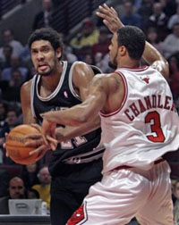 San Antonio Spurs' Tim Duncan, left, heads to the basket past Chicago Bulls' Tyson Chandler during the first quarter Monday, Nov. 7, 2005, in Chicago. 