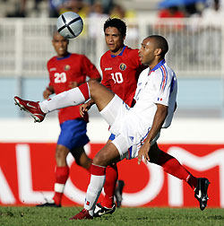 Thierry Henry (front) controls the ball as Walter Centano of Costa Rica looks on at Dillon stadium near Fort de France , Martinique, November 9, 2005. 
