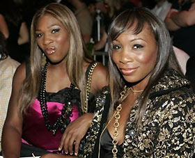 Tennis stars Venus, right, and Serena Williams sit in the stands before the Marc Jacobs 2006 spring-summer show during Fashion Week, Sept. 12, 2005 in New York.
