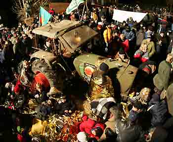 Anti-nuclear protesters surround a tractor where farmers chained themselves on the chassis of a tractor in the small village of Grippel late November 21, 2005, as they block the transport road to the Gorleben interim storage facility. The controversial shipment of twelve Castor containers with spent nuclear fuel arrived in Dannenberg on their way from the French reprocessing plant of La Hague to the Gorleben interim storage facility in northern Germany. 