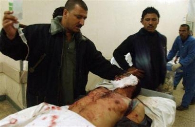 A man is treated at a local hospital after being wounded by suicide car bomber in Kirkuk, Iraq, Tuesday, Nov. 22, 2005.