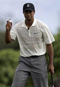 Golfer Tiger Woods reacts after a birdie on the sixth role during the first round at the PGA Grand Slam of Golf on the Poipu Bay golf course Tuesday, Nov. 22, 2005, in Poipu Beach, Hawaii. 