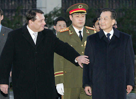Czech Prime Minister Jiri Paroubek (L) gestures to his Chinese Prime Minister Wen Jiabao, accompanied by an unidentified Chinese military official, during the welcoming ceremony at the Czech Government headquarters upon his arrival in Prague, December 8, 2005.