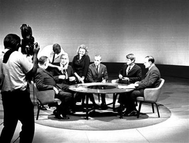 A KGO-TV cameraman, left, prepares to tape a presidential debate, between Senator Eugene McCarthy, fourth left, and Sen. Robert Kennedy, second right, in this June 1, 1968, in San Francisco. From second left: ABC White House correspondent William Lawrence, an unifentified floor man, McCarthy, producer Peggy Whedon, moderator Frank Reynolds, Kennedy, and ABC political correspondent, Robert Clark.