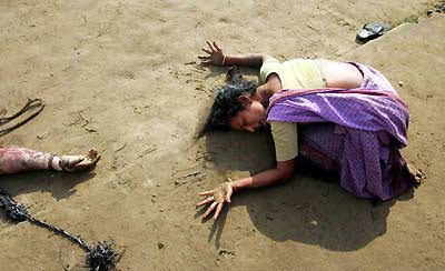An Indian woman mourns the death of a relative who was killed after an Indian Ocean tsunami hit Cuddalore, Tamil Nadu in this December 28, 2004 file photo. Countries around the Indian Ocean hold ceremonies on December 26, 2005 to remember the many thousands who died in last year's tsunami, one of the deadliest disasters in modern history. A year on, a huge reconstruction operation has brought hope but the pain of losing loved ones is still raw, some survivors say. [Reuters]