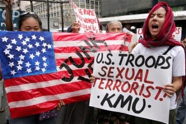 Filipino female protesters hold signs during a protest near the U.S. embassy in Manila November 5, 2005.