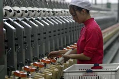 A woman works at a textile factory in Xiangfan, Hubei province, China December 31, 2005. 