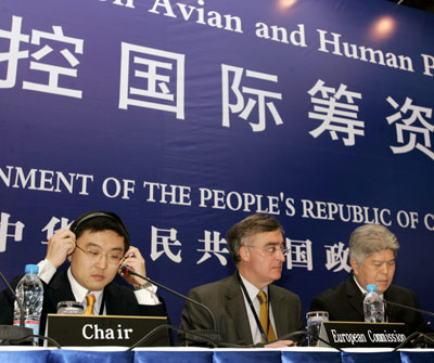 Deputy Director-General of China's Ministry of Foreign Affairs Wang Xiaolong sits with other officials at the opening ceremony of the "International Pledging Conference on Avian and Human Pandemic Influenza" in a hotel in Beijing January 17, 2006. [Reuters]