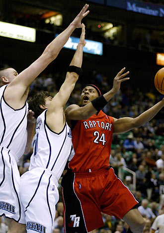 Toronto Raptors forward Morris Peterson (R) tries to get a shot around Utah Jazz defenders Gordon Giricek (C) and Greg Ostertag (L) during the first half of their NBA game in Salt Lake City January 17, 2006. [Reuters]