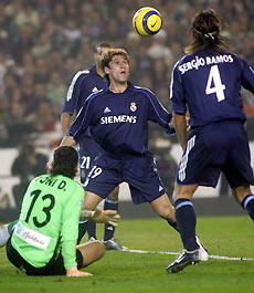 Real Madrid's Antonio Cassano of Italy (C) looks at the ball next to Real Betis' Antonio Doblas (L) and Sergio Ramos before scoring during their Spanish King's cup soccer match quarter-final first leg at the Manuel Ruiz de Lopera stadium in Seville January 18, 2006.