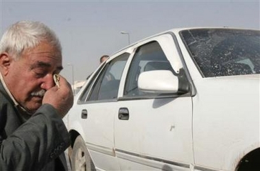 An Iraqi man cries for a wounded relative at the scene of a roadside bomb that targeted an Iraqi patrol, Sunday, Jan. 22, 2006, in Baghdad, Iraq.