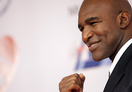 Boxer Evander Holyfield gestures as he arrives at the 2006 "Musicares Person of the Year" gala in Los Angeles February 6, 2006. The event celebrates the extraordinary musical achievements and the philanthropic commitment to arts, environmental and humanitarian causes of an individual. [Reuters]
