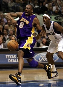 Los Angeles Lakers' Kobe Bryant (8) loses control of the ball as he drives to the basket past Dallas Mavericks' Josh Howard (5) in the second half of NBA basketball action in Dallas, Tuesday, Feb. 7, 2006.