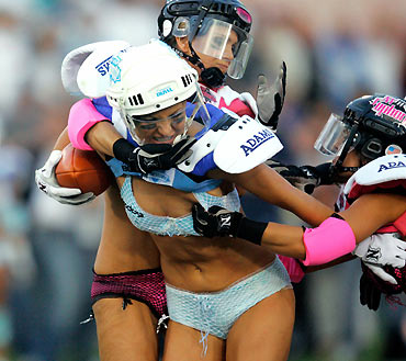 Los Angeles Temptation(blue) play against New York Euphoria during the third annual Lingerie Bowl football game in Los Angeles February 5, 2006. The 30-minute game features models playing full-contact football in lingerie and airs locally on pay-per-view during half time of the NFL's Super Bowl XL football game. 