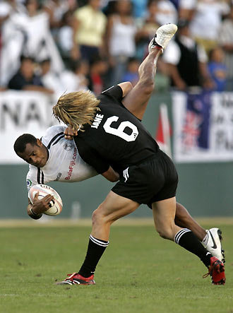 New Zealand's Cory Jane (R) lifts and tackles Fiji's Neumi Nanuku during their cup semi-final rugby match at the 2006 IRB USA Sevens rugby tournament in Carson, California February 12, 2006. Jane was assessed a penalty for a dangerous tackle. Fiji beat New Zealand but lost to England in the final.