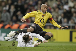Arsenal's Thierry Henry fights for the ball with Real Madrid's Sergio Ramos during their Champions League first knockout first leg soccer match at Santiago Bernabeu stadium in Madrid, February 21, 2006. 
