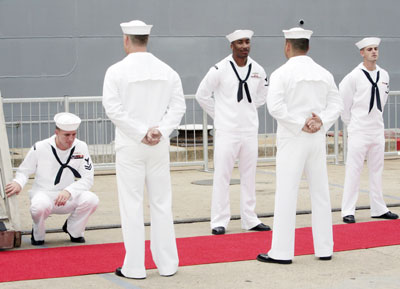 Crew members of the USS Park Royal guided missile cruiser await U.S. Secretary of State Condoleezza Rice's visit at a naval base in Sydney March 16, 2006. Rice is on a three-day visit to Australia.